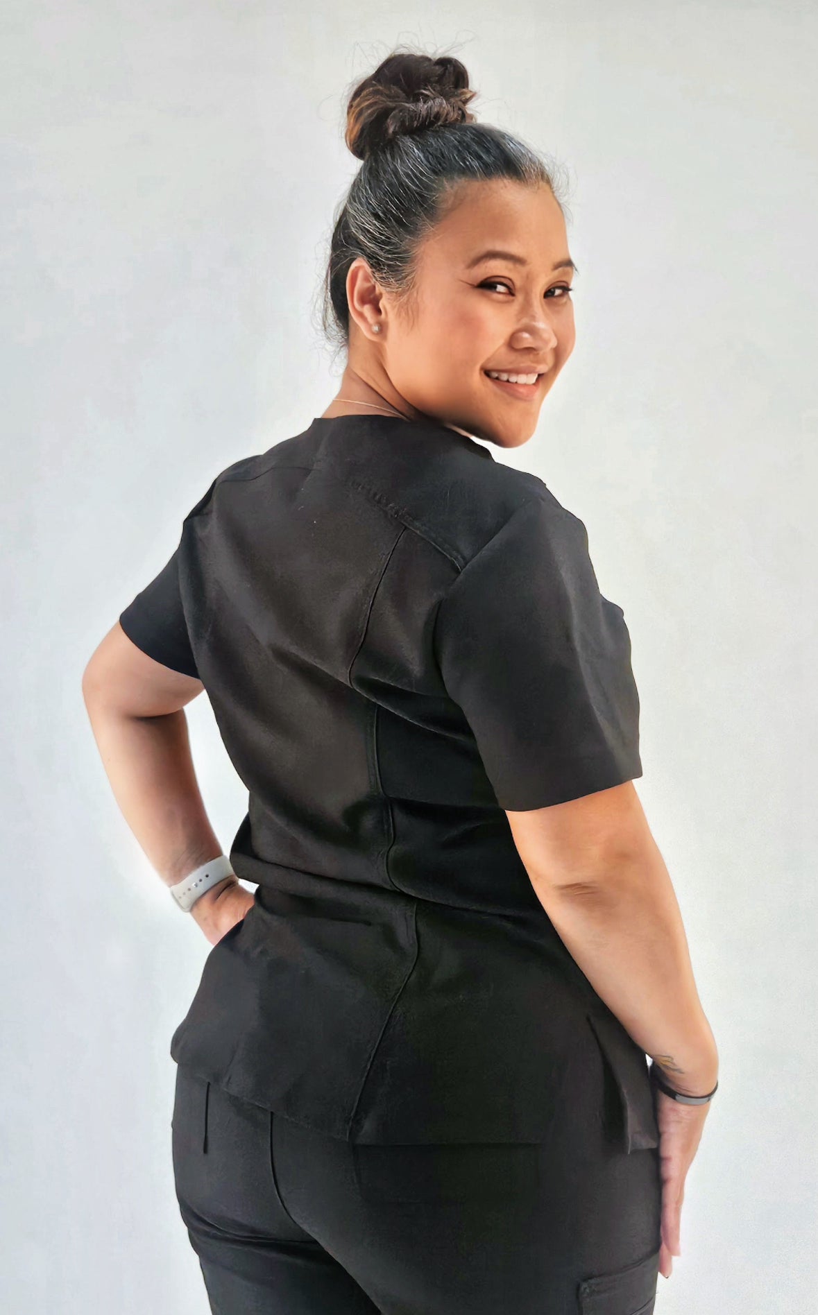 Back view showing flattering seams, contoured waistband, and professional straight-leg design.