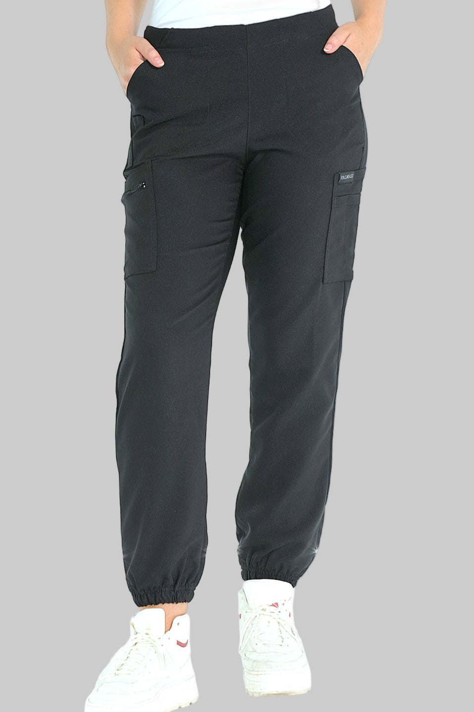 Front view of high-waisted black jogger scrub pants featuring 9 functional pockets and a flattering curved silhouette.