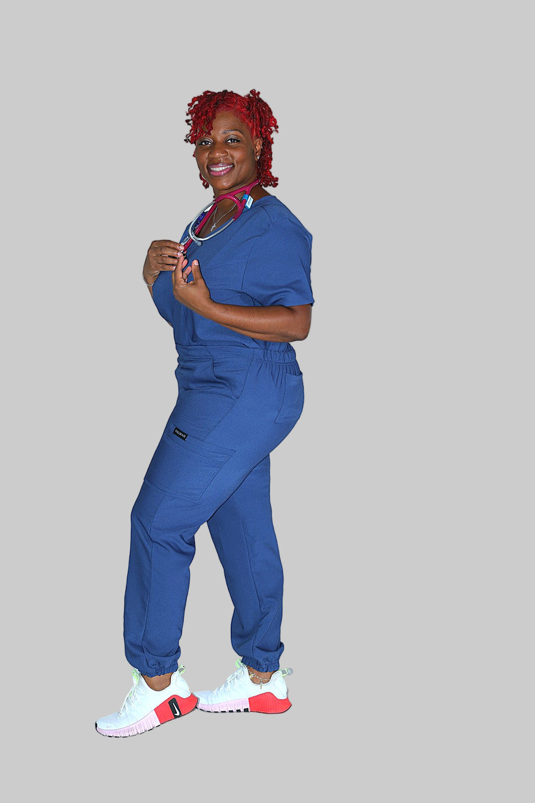 Women’s blue scrub joggers with relaxed curvy fit and multi-pocket design.