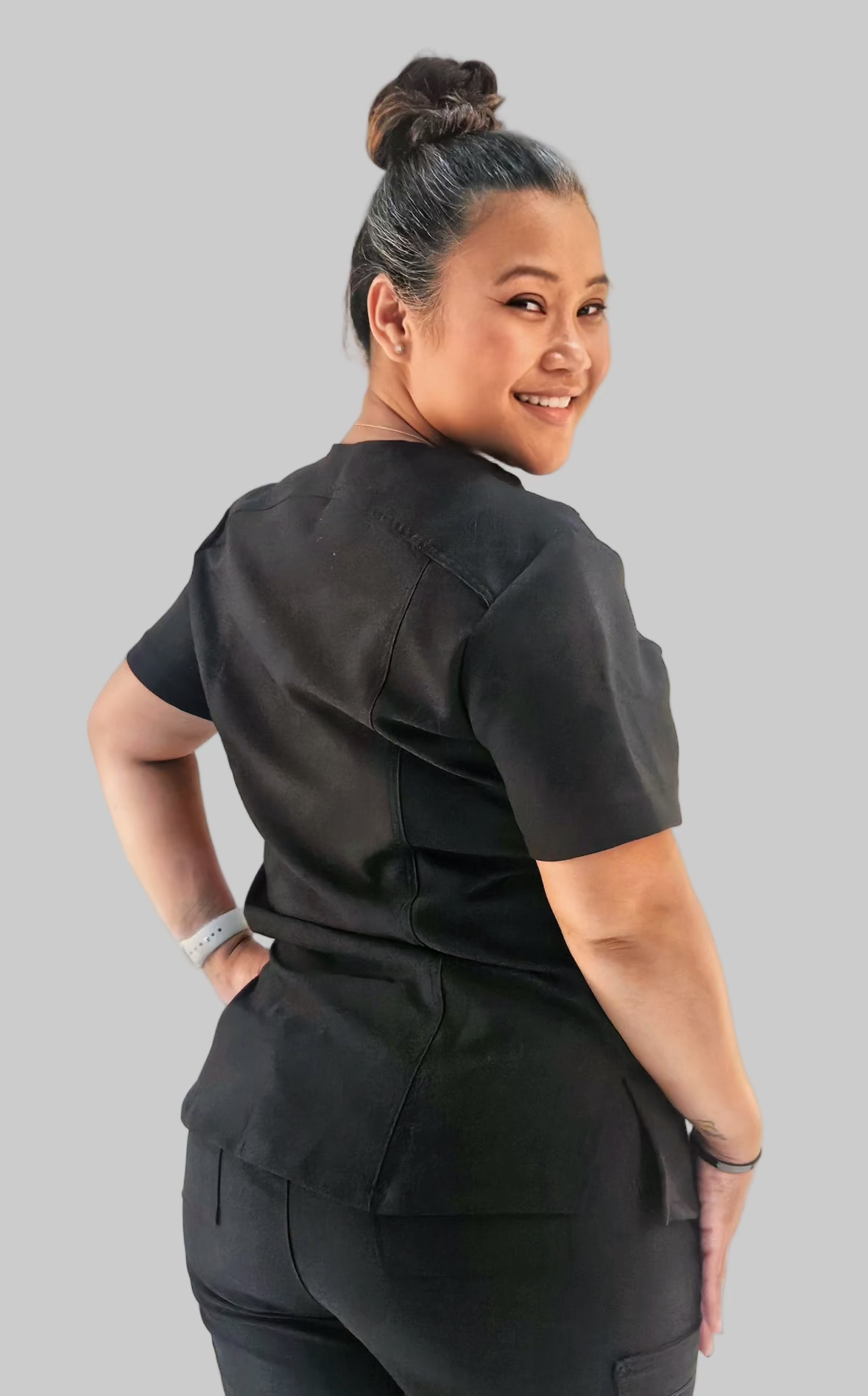 Luxe breathable curvy-fit scrub top featuring shaping seams, stretch fabric, and front pockets.