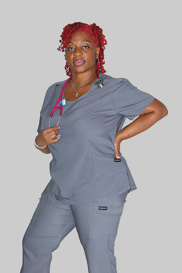 Grey scrub top with two front pockets and princess seams for curvy fit.