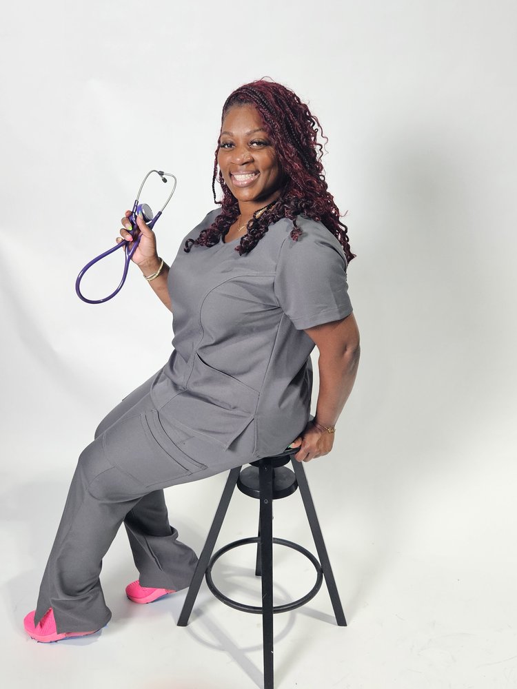 Nurse sitting wearing grey scrubs, cargo pants